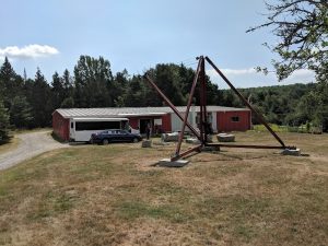 Maine Granite Industry Historical Society Museum in Acadia National Park sits alongside a red outbuilding and grounds.