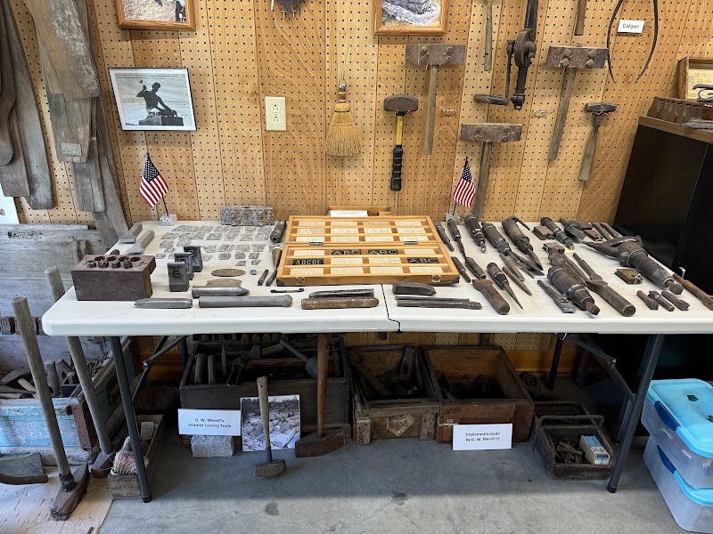 Interior of the Maine Granite Industry Historical Society Museum in Acadia National Park, showcasing historic quarry tools and wooden tool blocks.