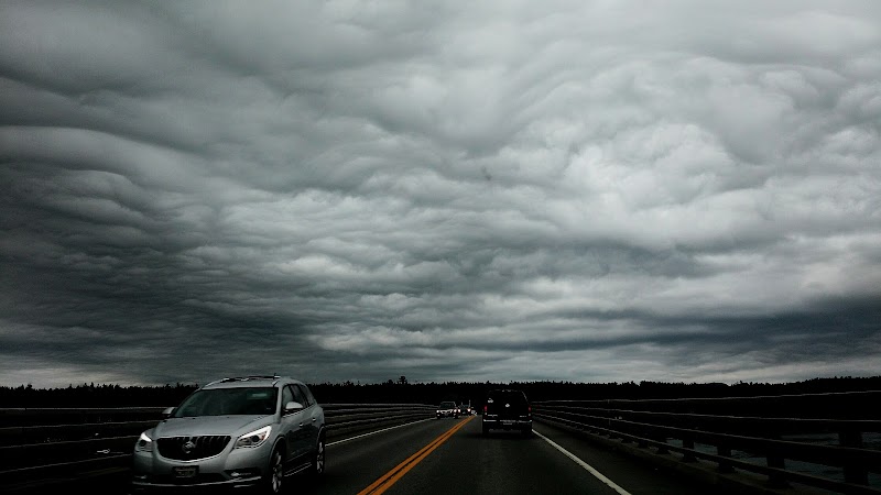 Dramatic highway scene near Hancock Point, Acadia National Park, under heavy storm clouds.