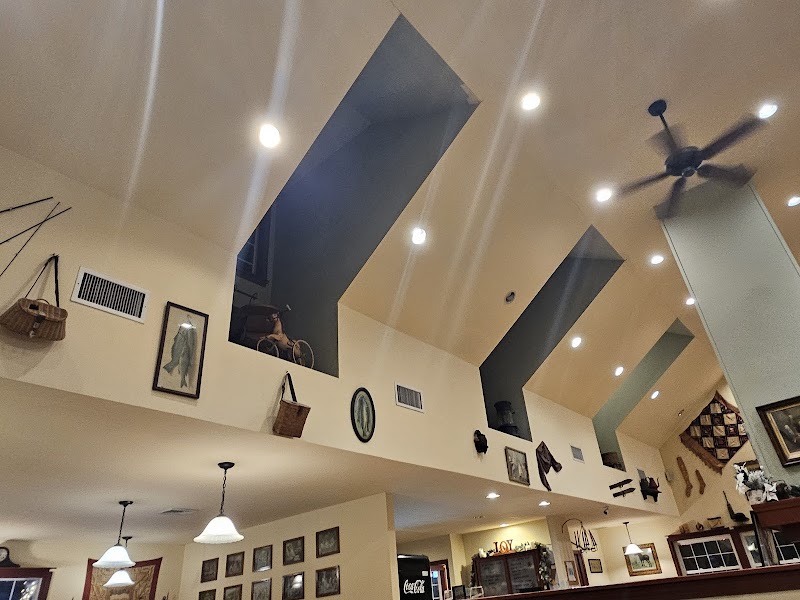 Interior view of a park-side dining area in Acadia National Park, featuring angled ceilings, hanging lights, rustic decor.