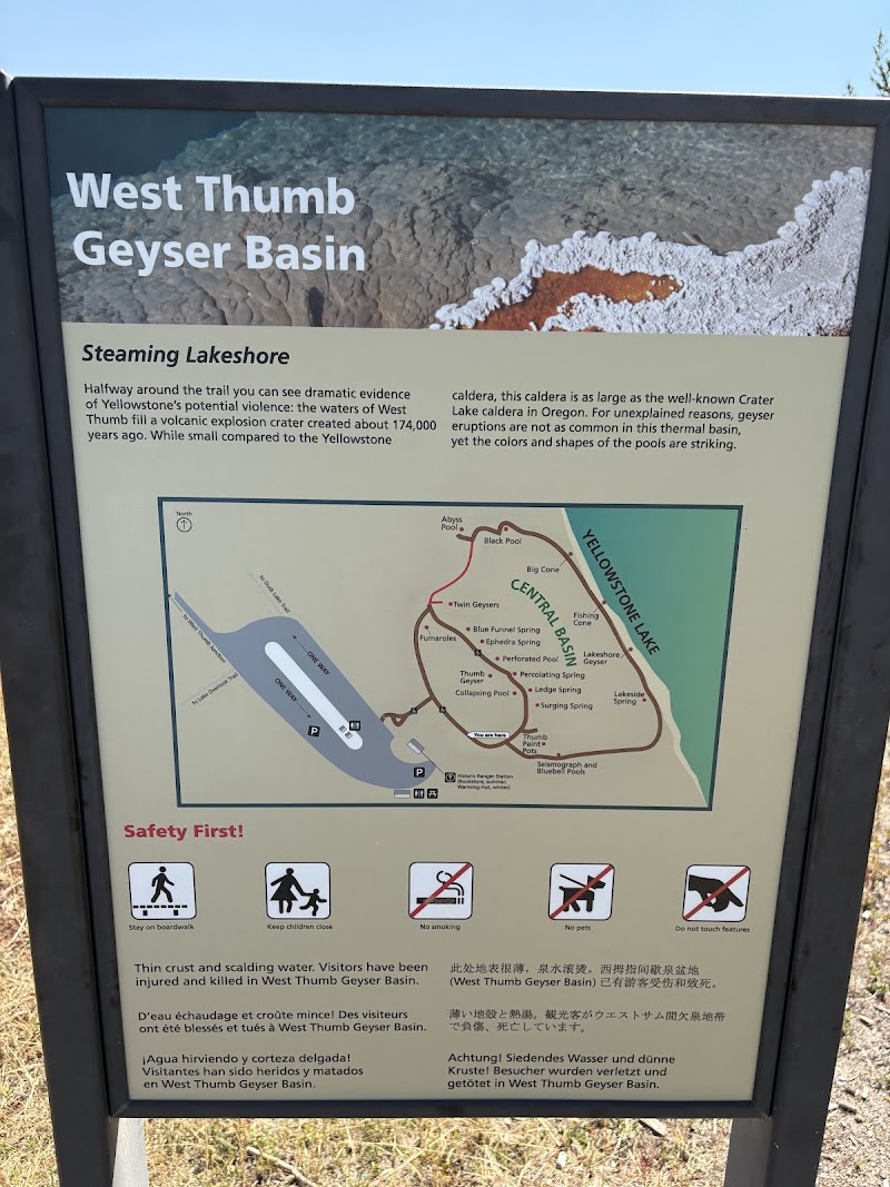 Informational sign about West Thumb Geyser Basin with a map and safety icons at Yellowstone National Park.