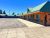 Lodging row with teal-green roofs and orange walls along a paved lot in Yellowstone National Park.