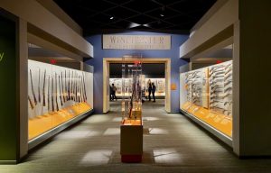 Winchester firearms display at Yellowstone National Park’s visitor center, showcasing historical rifles in glass cases.