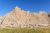 Door Trail in Badlands National Park features layered eroded cliffs under a clear blue sky.