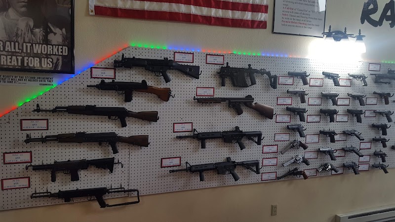 Rows of rifles on a pegboard wall with red price tags and neon trim in a Yellowstone National Park gift shop.