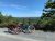 Three bicycles on a gravel overlook at Acadia National Park, with forested hills and a distant lake under a clear blue sky.
