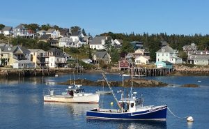 Stonington harbor with colorful seaside houses and fishing boats in Acadia National Park.