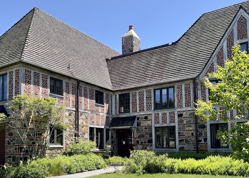 Birch Harbor building at Acadia National Park with a brick-and-stone facade under a bright blue sky.