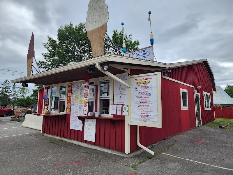Red lobster shack storefront in Acadia National Park with a menu board and service window.