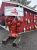 Lobster statue and harbor shack with buoys along a red building near Acadia National Park, welcoming visitors.