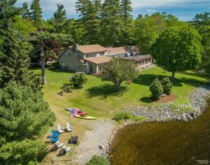 Alamoosook Lakeside Inn exterior along a rocky shoreline in Acadia National Park, Maine.