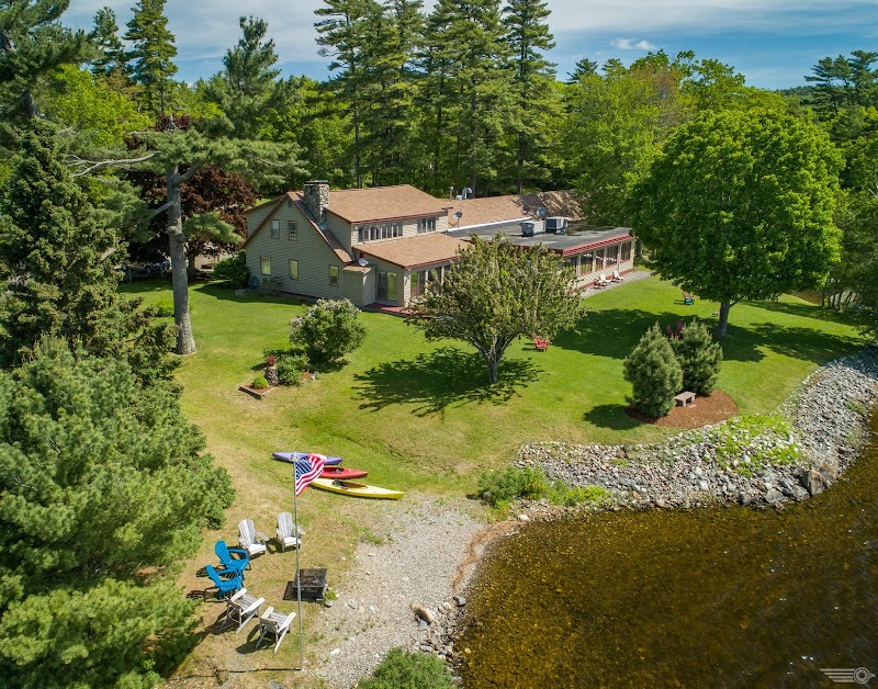 Alamoosook Lakeside Inn exterior along a rocky shoreline in Acadia National Park, Maine.