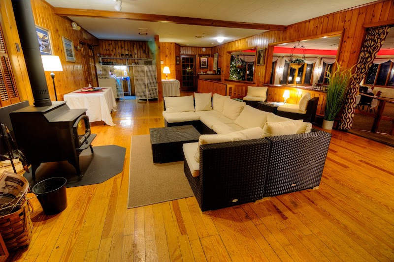 Inside a cozy lodge lobby with wicker seating and a wood stove at Acadia National Park.