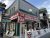 Ice cream shop exterior on a green clapboard building with a red striped awning in Acadia National Park.
