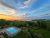 Sunlit pool terrace with ocean views and surrounding pines in Acadia National Park, near Frenchman Bay