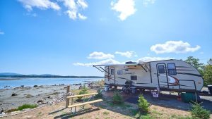 Narrows Too Campground along Acadia National Park’s coastline, with a RV trailer parked near the shore.
