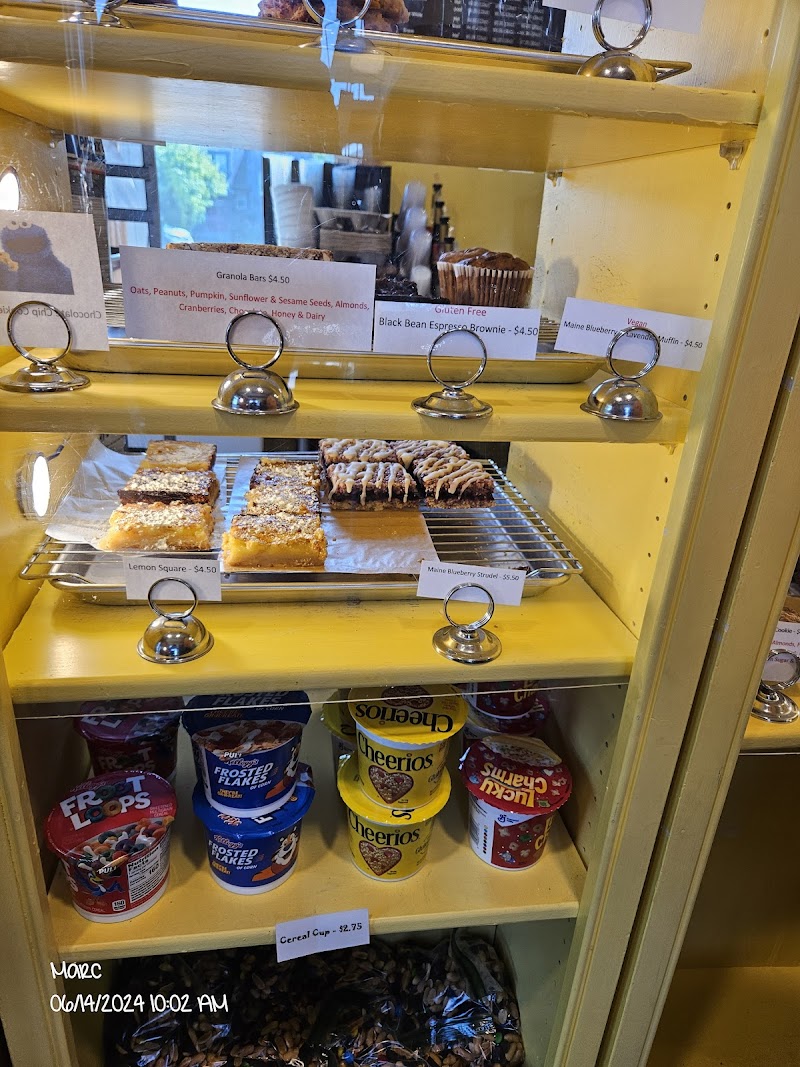Bright yellow display case at Acadia National Park shows lemon squares, blueberry pastries, granola bars and cereal cups on shelves.