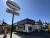 Ice cream shop storefront in Yellowstone National Park beneath a bright blue sky, with a large sign and small shop windows.