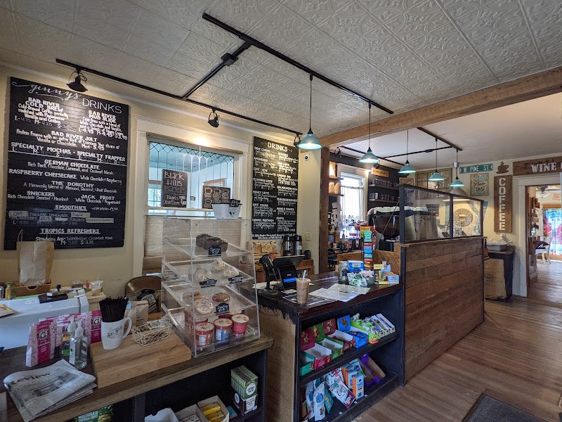 Inside a rustic gift shop at Badlands National Park, chalkboard menus, cafe counter, shelves of snacks and souvenirs.