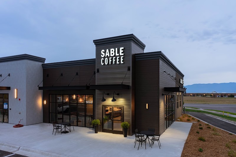 Modern coffee shop with dark siding and glass doors in Glacier National Park gateway town