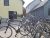 Row of bicycles parked outside a gift shop in Acadia National Park, near a yellow building with a dark door.