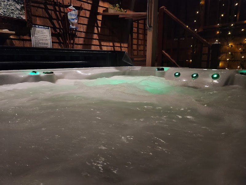 Indoor hot tub with green-lit jets at a lodge in Acadia National Park, showcasing a cozy indoor amenity.