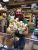 Inside a Yellowstone National Park gift shop, a staff member holds a bouquet of plush souvenir items for sale.