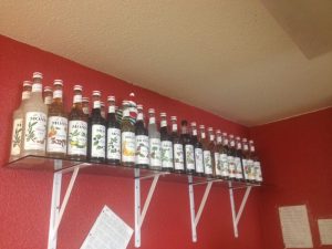 Yellowstone National Park interior with a long shelf of Monin syrup bottles lining a coffeehouse display.