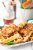 Crispy fried chicken on waffles with syrup streaming over the top, blurred drinks in the background at Arches National Park.