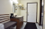 Bathroom and entry area of a guest lodging room in Acadia National Park, with a sink, coffee maker, bench seating, and a wall mirror.
