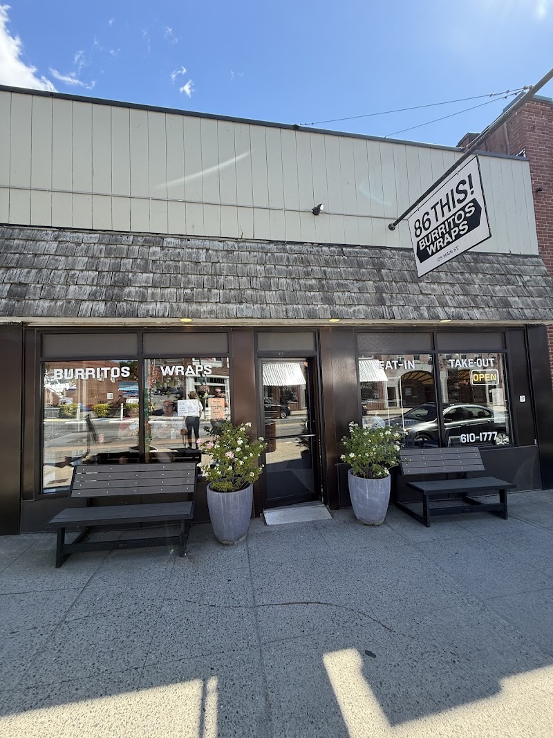 Storefront for a burritos wraps restaurant in Acadia National Park, with large glass windows and outdoor seating nearby.