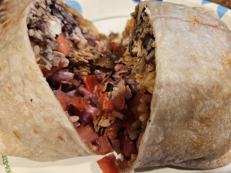 Close-up of a cut-open burrito with rice, beans, and vegetables served in Acadia National Park.