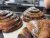 Close-up of flaky cinnamon rolls dusted with sugar on a display tray at Arches National Park bakery.
