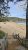 Sand Beach at Acadia National Park stretches along the shore, framed by pines, with a sandy shoreline and blue Atlantic in view.