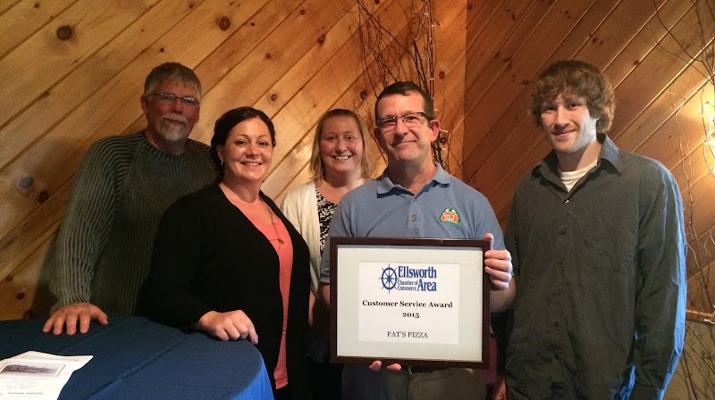 Award ceremony inside a pizza restaurant in Ellsworth area of Acadia National Park, during a Customer Service Award presentation.