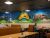 Interior of a pizza restaurant in Ellsworth, Acadia National Park, with a colorful mural.
