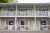 Front view of a two-story motel with green doors and balconies in Acadia National Park.