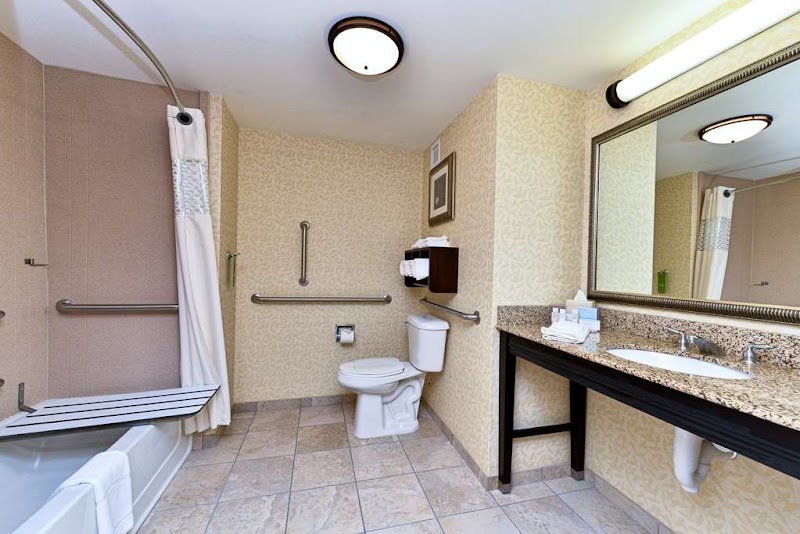 Ellsworth hotel bathroom near Acadia National Park, showing a tiled floor, granite countertop, and accessible fixtures.