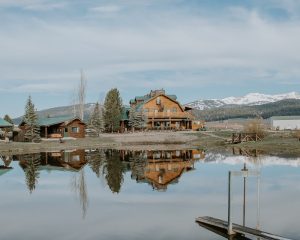 Rustic lodge exterior with log beams and spacious porch