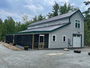 Campground administration building at a woodland campground in Acadia National Park, with a metal roof and screened guest area.