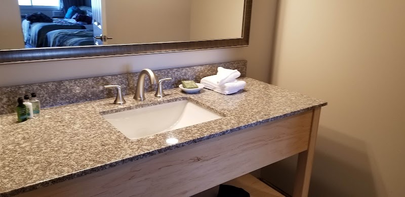 Bathroom vanity with granite countertop and sink at a seaside lodging in Acadia National Park.