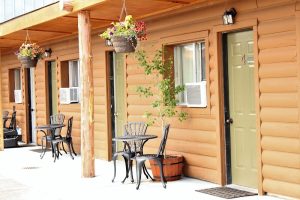 Rustic lodge exterior with log siding and wraparound porch