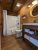Wood-paneled lodge bathroom with bathtub and vanity in Yellowstone National Park.