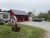 Red bakery storefront beside a gravel parking area in Acadia National Park.