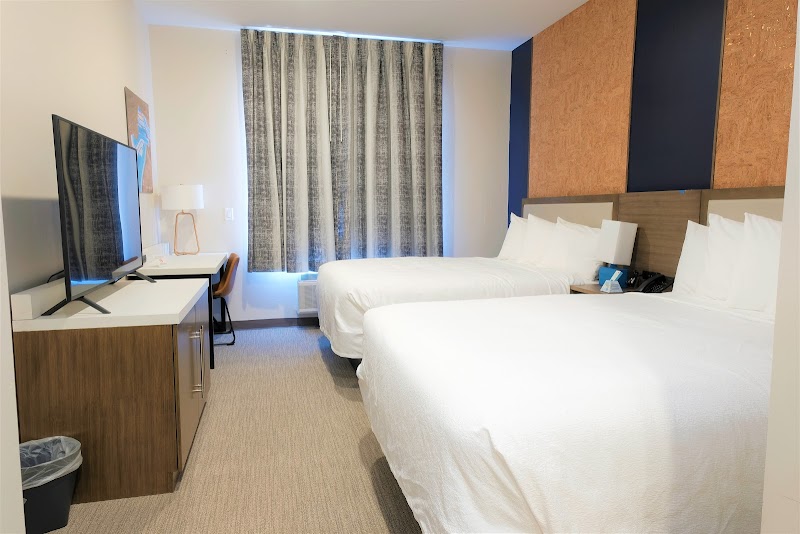 Guest room with two queen beds at a Moab lodging near Arches National Park, featuring modern decor.