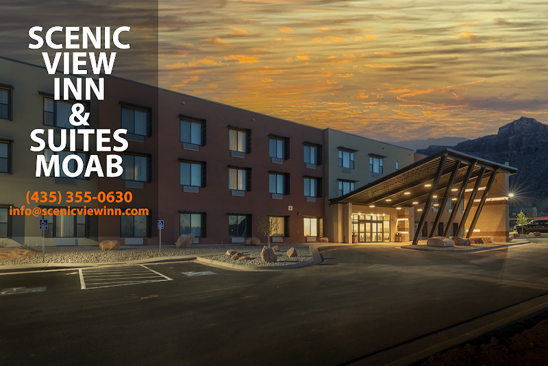 Exterior view of a Moab hotel at dusk with a desert mountain backdrop near Arches National Park.