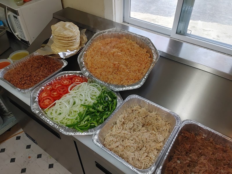 Acadia National Park restaurant prep area with tortillas, beans, rice, and fresh vegetables laid out for takeout orders.