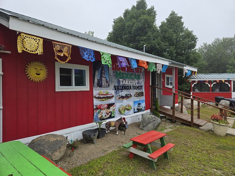Vibrant red restaurant building in Acadia National Park with festive banners and outdoor seating.