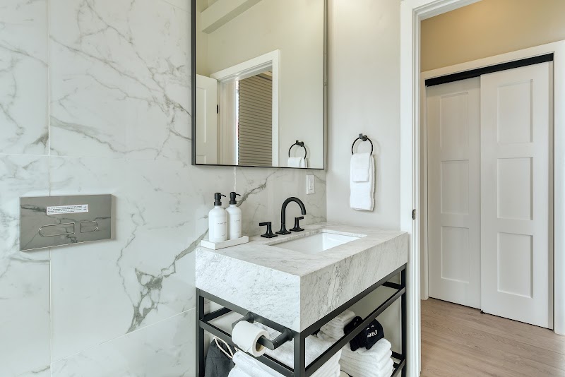 Guest bathroom in Big Bend lodging features a marble vanity with a black faucet and modern hardware.