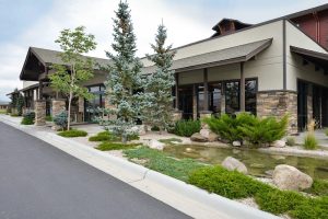Exterior of a lodge-style building at Yellowstone National Park with stone accents and well-kept landscaping.